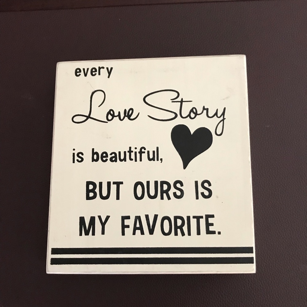 Wooden sign “Every love story is beautiful..”